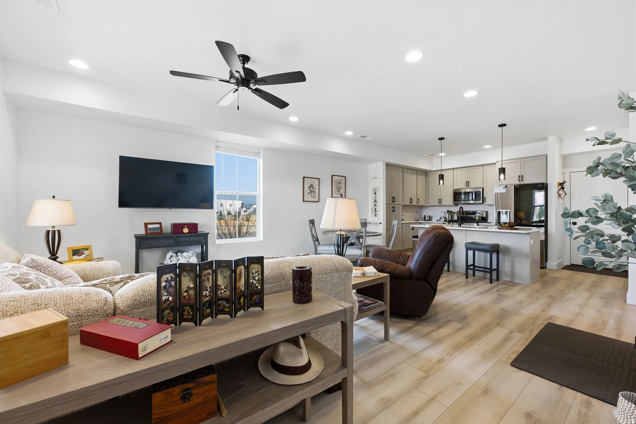 Living room with light wood-style flooring, recessed lighting, and a ceiling fan