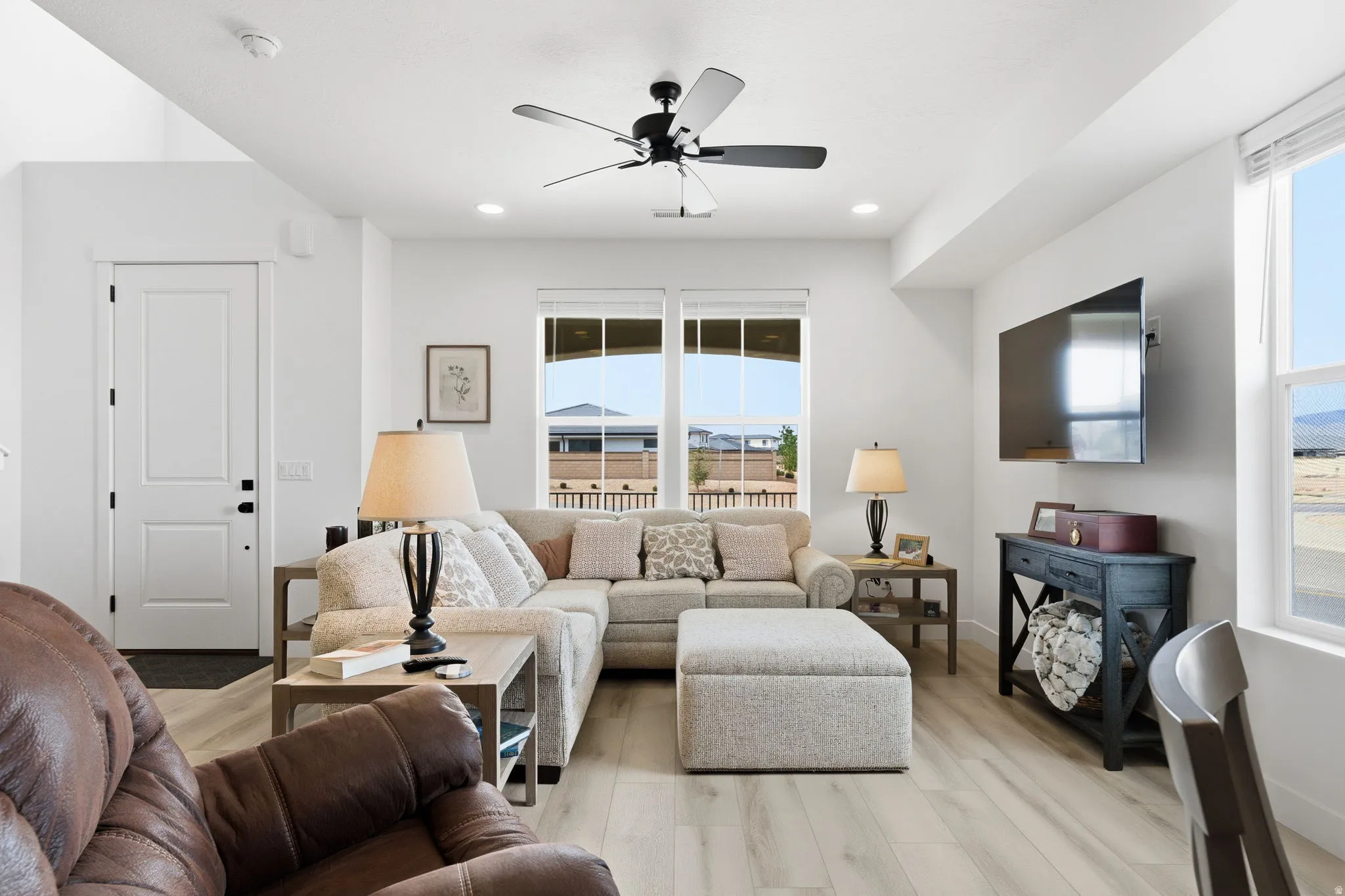 Living area with ceiling fan, wood finished floors, and recessed lighting