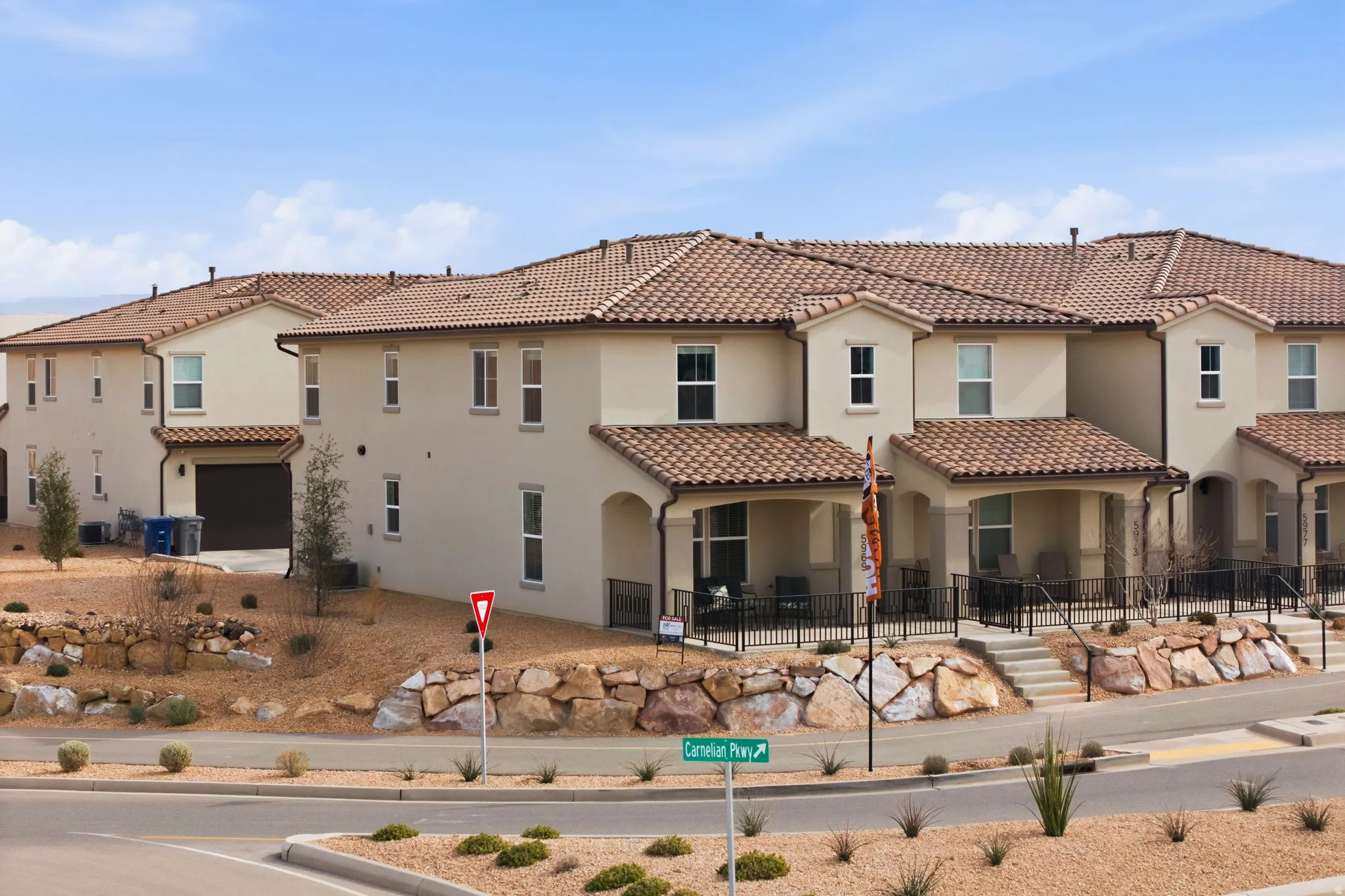 Rear view of property with stucco siding, a tile roof, and a patio area