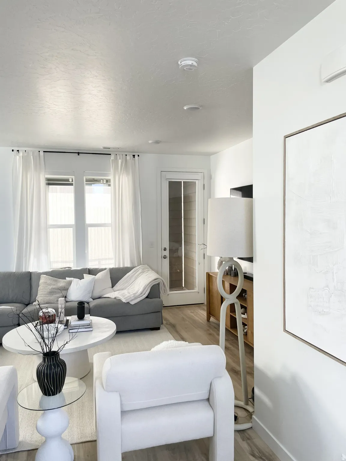 Living room featuring light wood-style floors and a textured ceiling