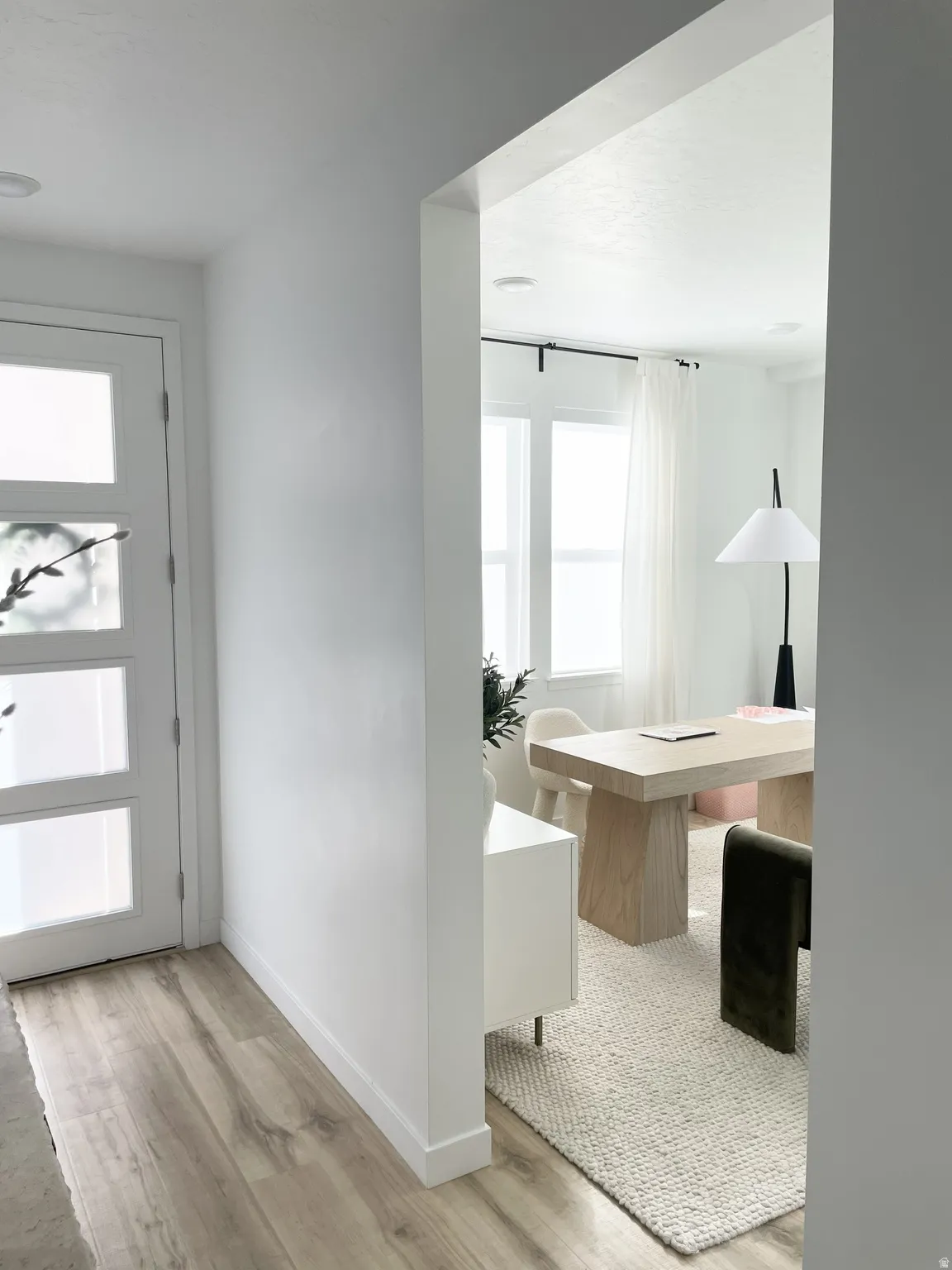 Foyer entrance with light wood-type flooring and baseboards