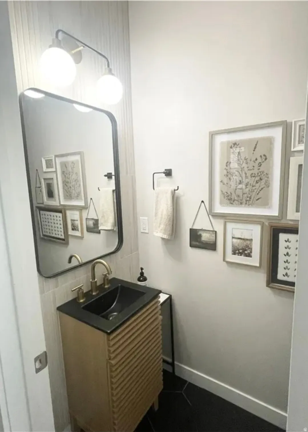 Bathroom with vanity and dark tile patterned floors