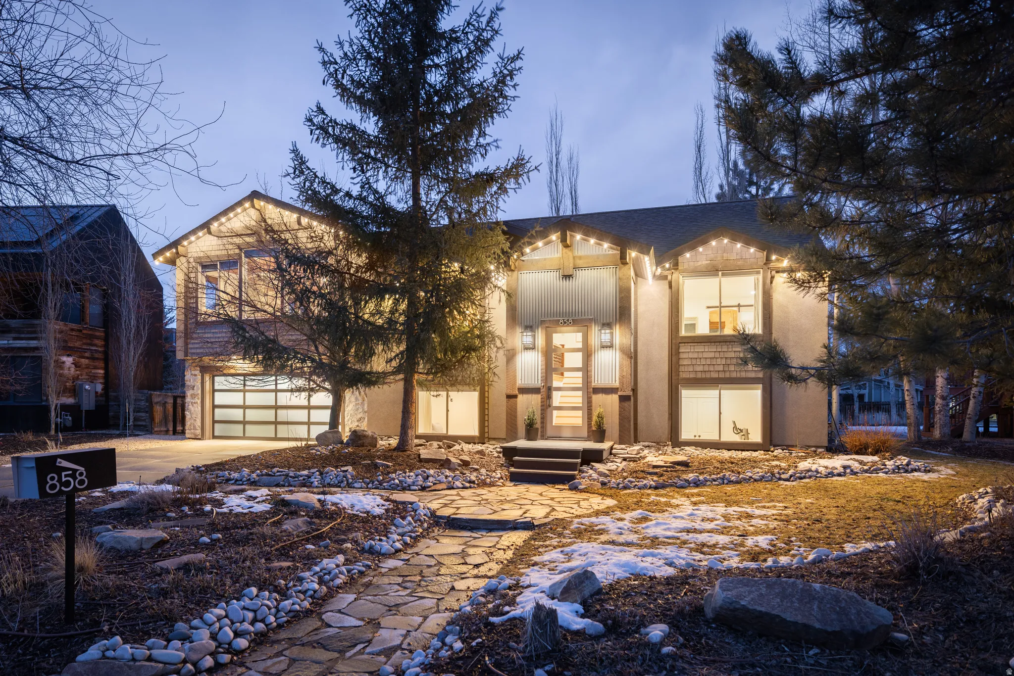 View of front facade with driveway and an attached garage