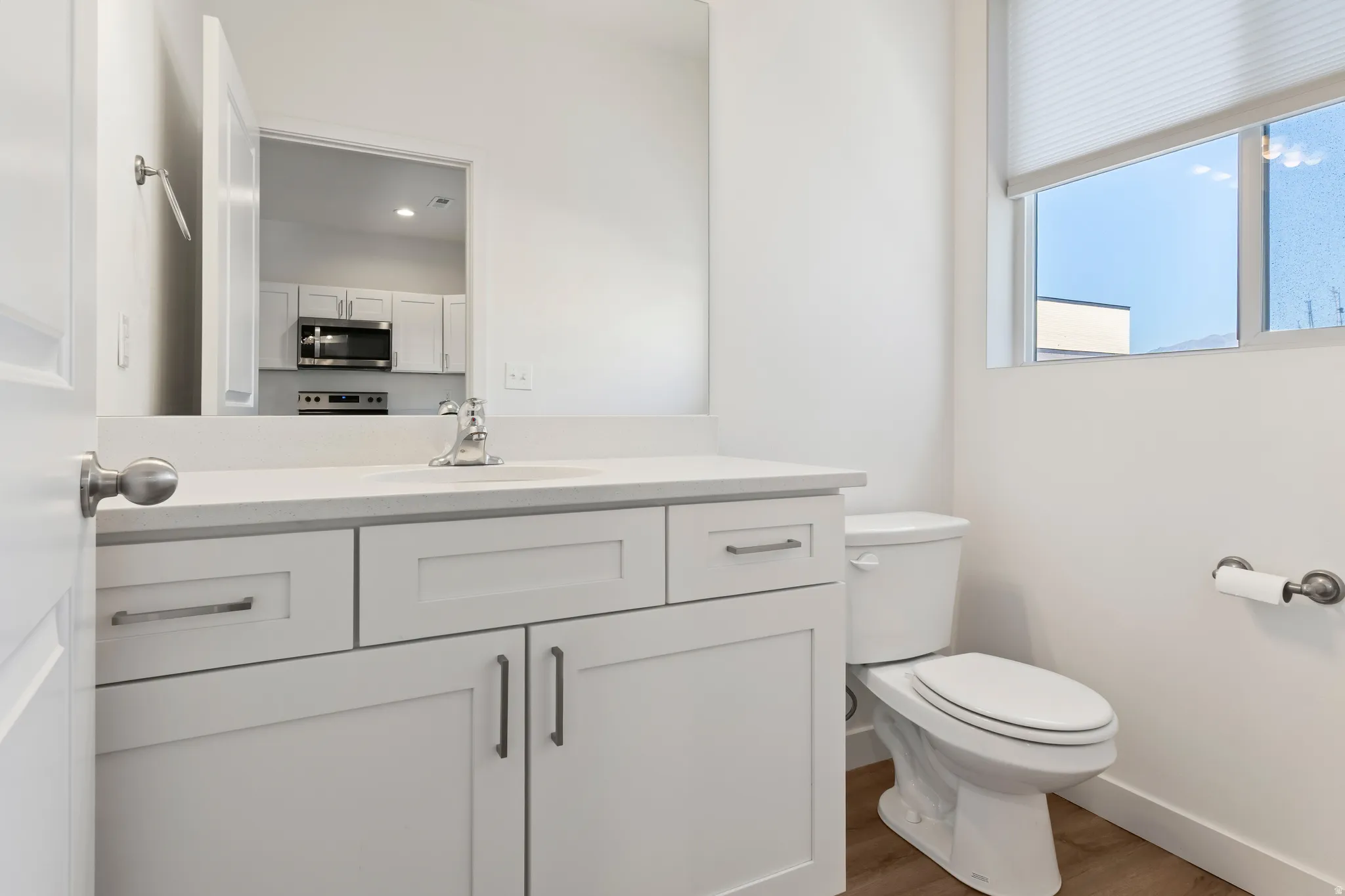 Bathroom featuring vanity and wood finished floors