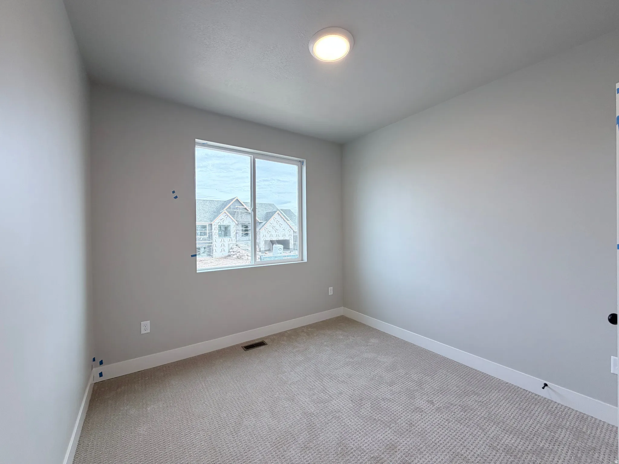 Spare room with carpet flooring and baseboards