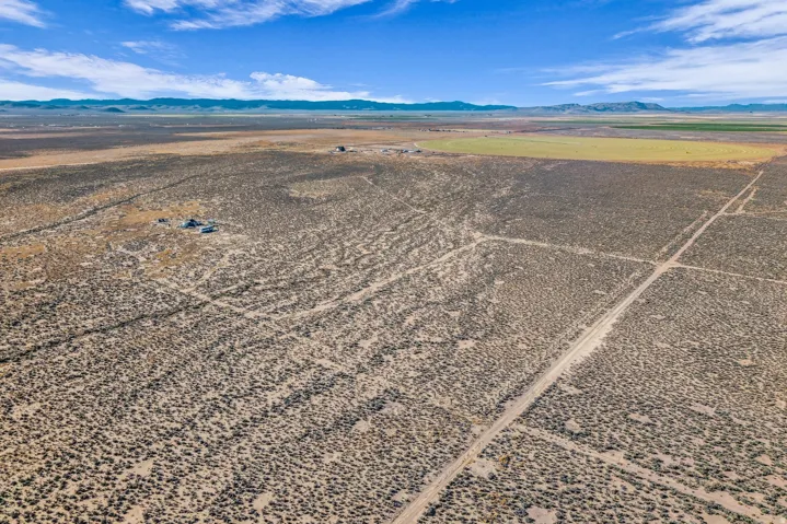 Aerial view of sparsely populated area with a desert landscape and a mountainous background