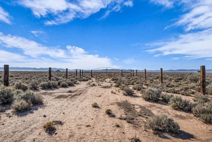 View of yard featuring view of desert landscape and a mountain view