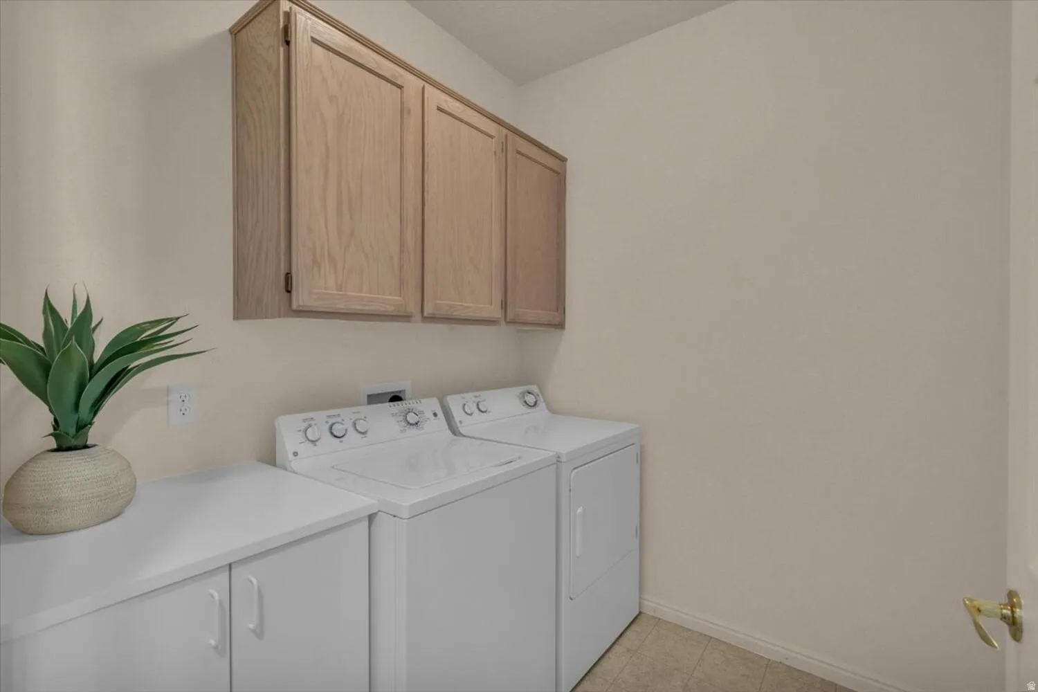 Laundry area featuring cabinet space and separate washer and dryer