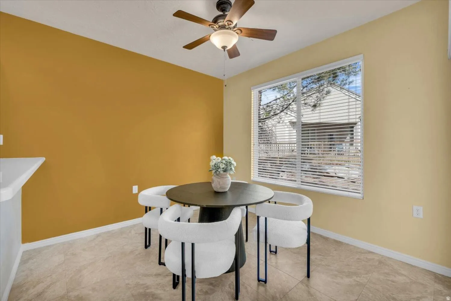 Dining space with baseboards and a ceiling fan