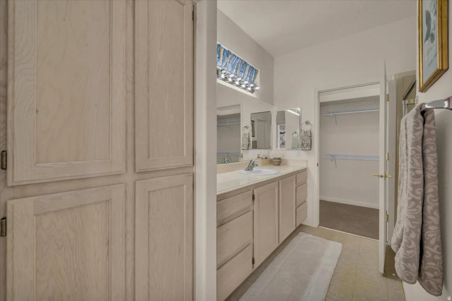 Full bath with vanity and a spacious closet