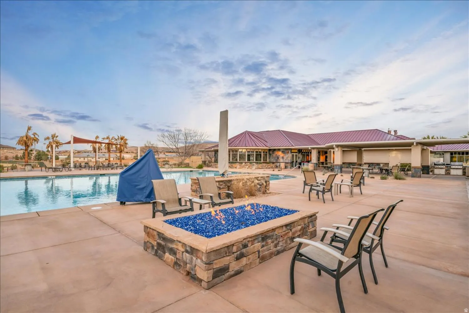 Community pool with a fire pit and a patio area
