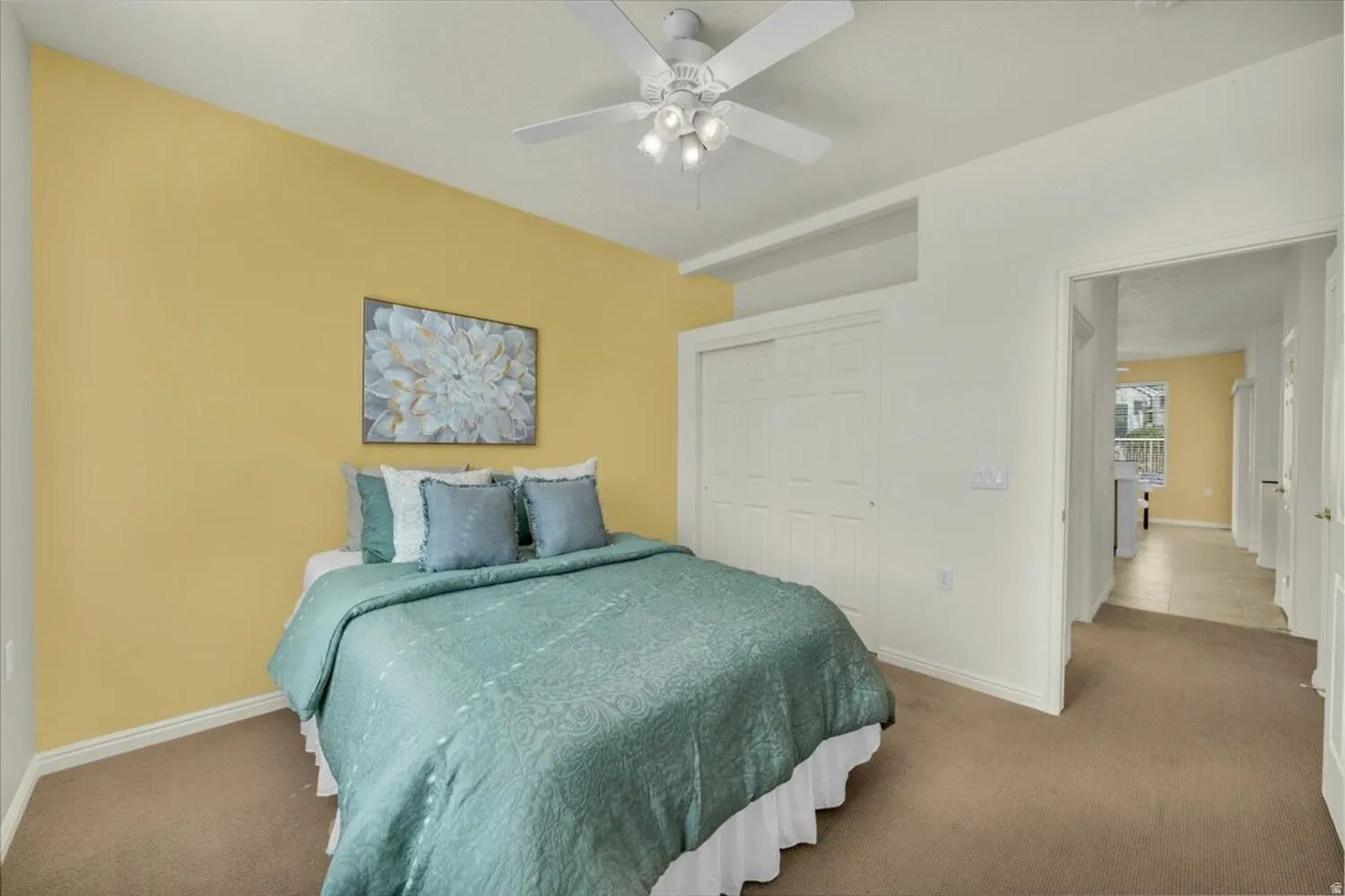 Bedroom featuring a closet, carpet floors, and ceiling fan