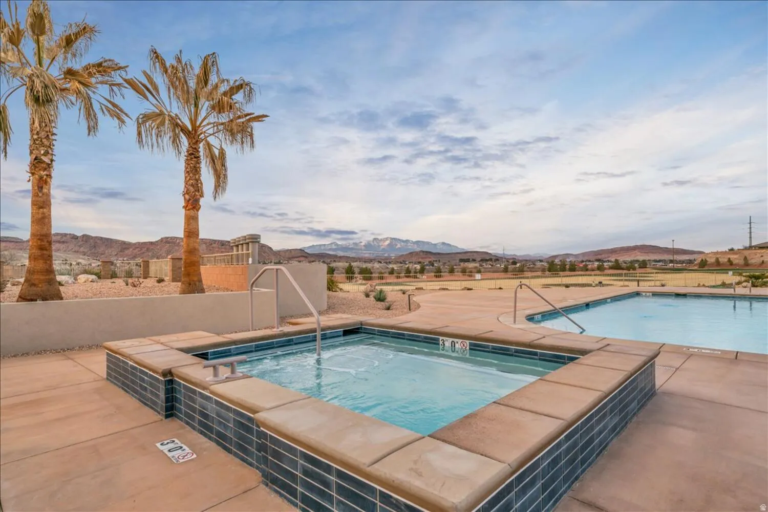 Community pool with a mountain view, a patio area, and a community hot tub