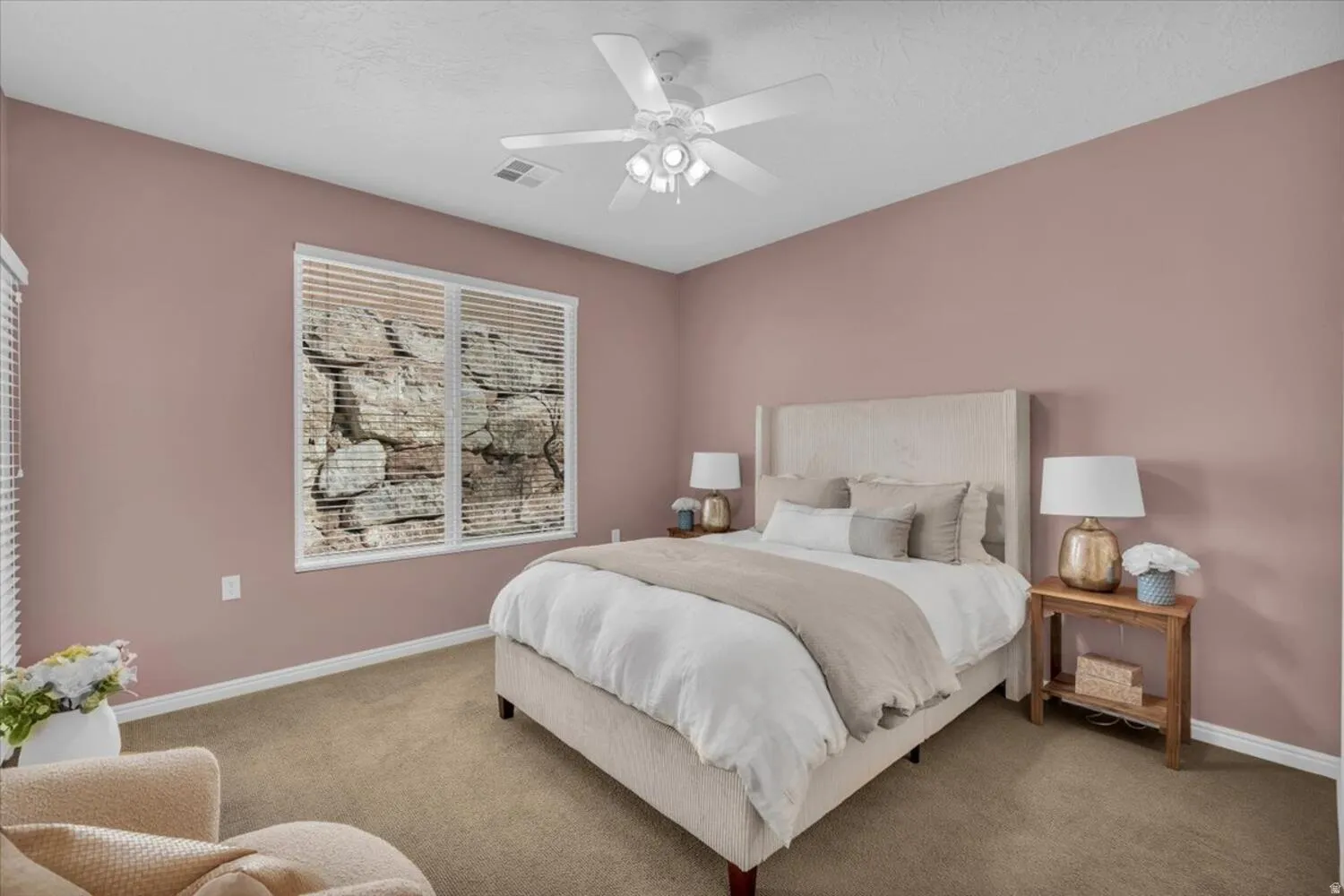 Carpeted bedroom with baseboards and a ceiling fan