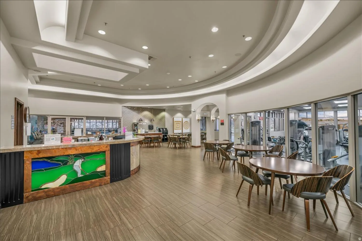 Reception featuring recessed lighting, a tray ceiling, and arched walkways