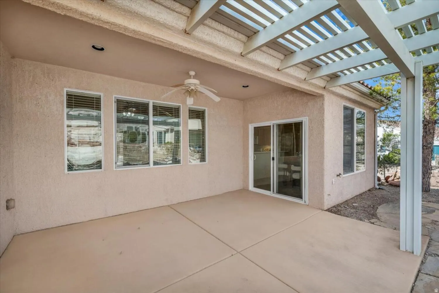 View of patio featuring ceiling fan and a pergola