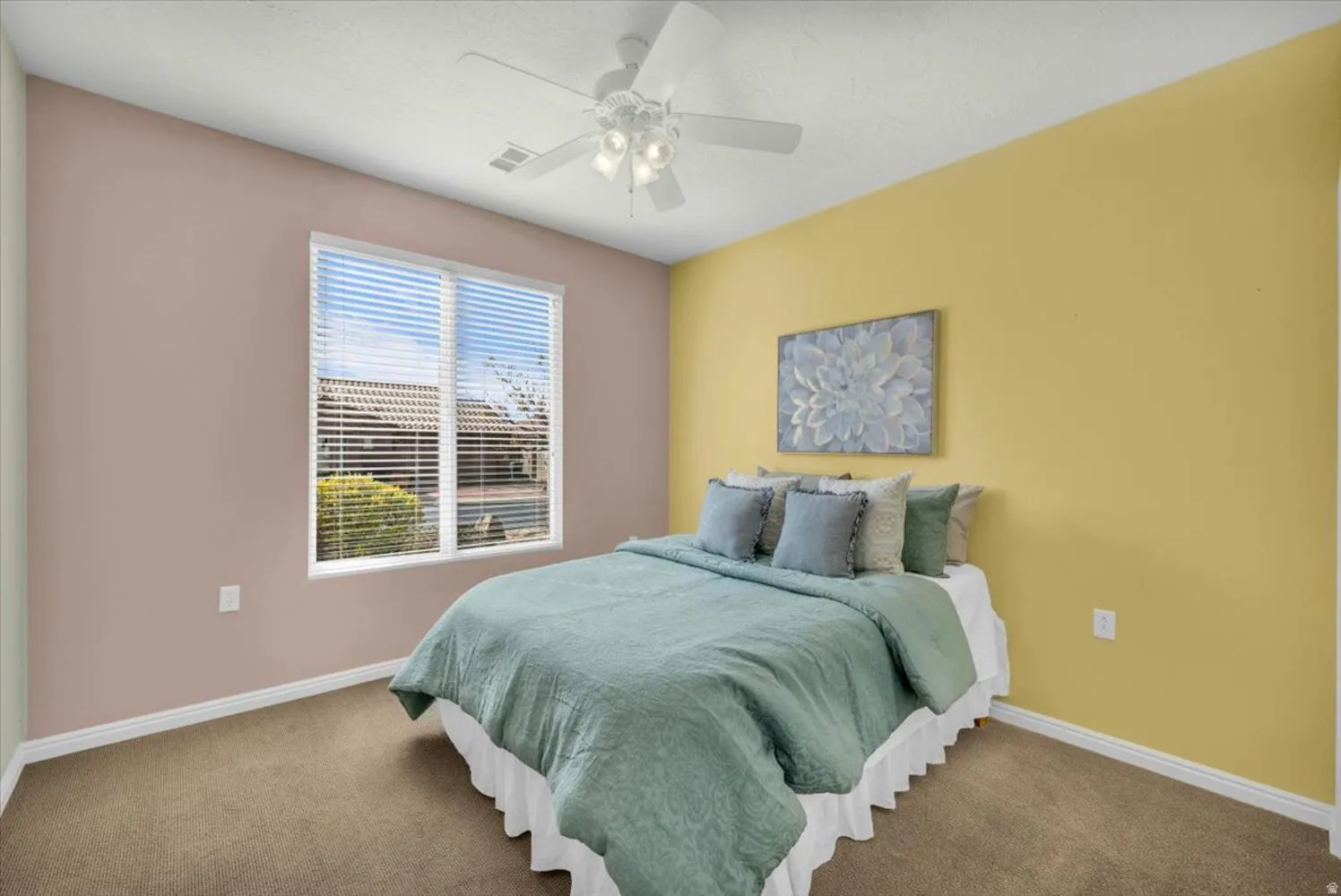 Bedroom featuring ceiling fan and carpet flooring