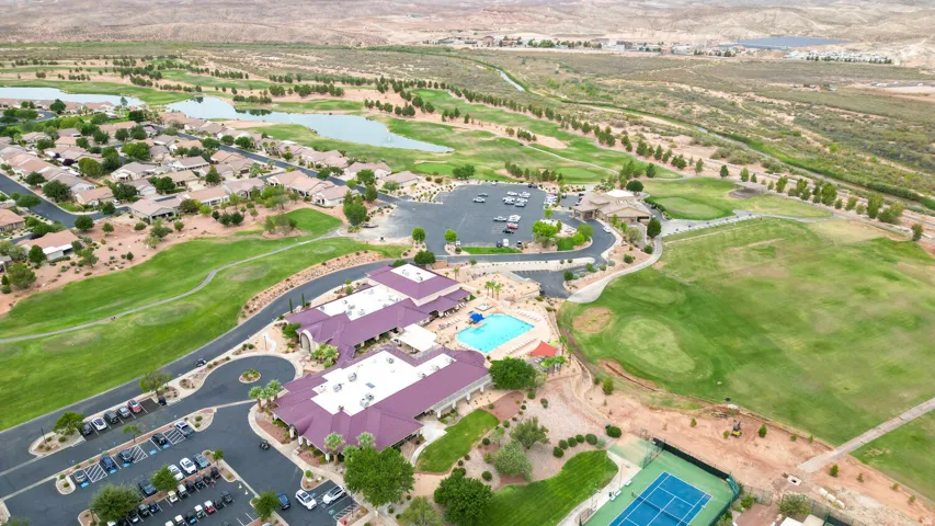 Aerial view of property and surrounding area with a golf club and a large body of water