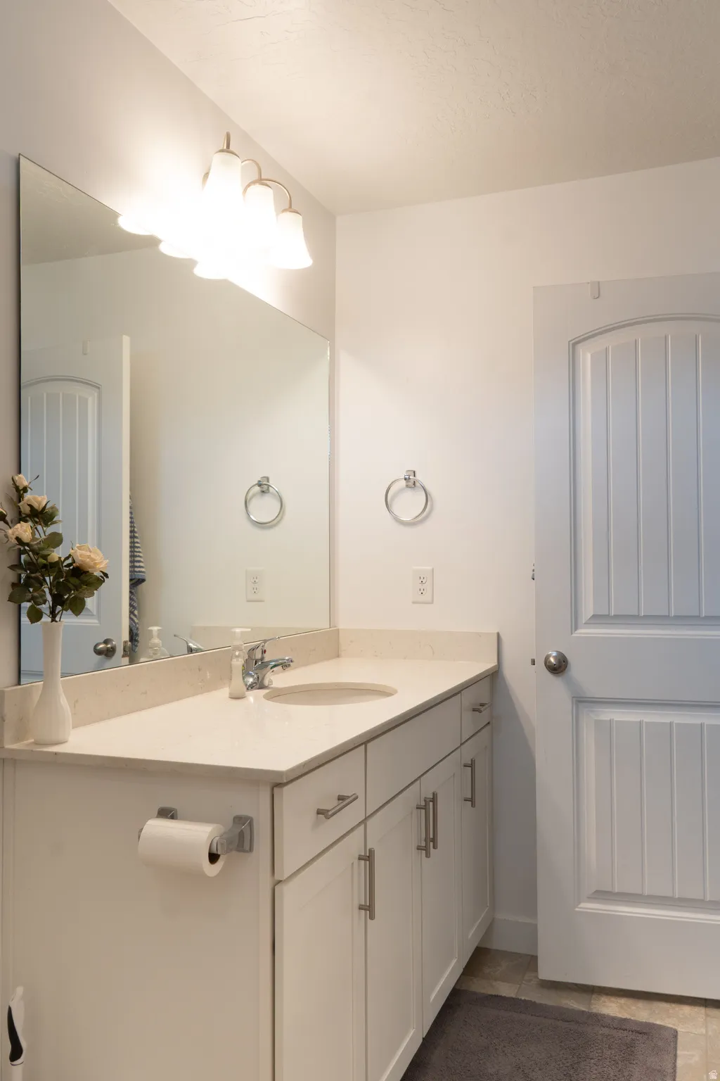 Bathroom featuring vanity and baseboards