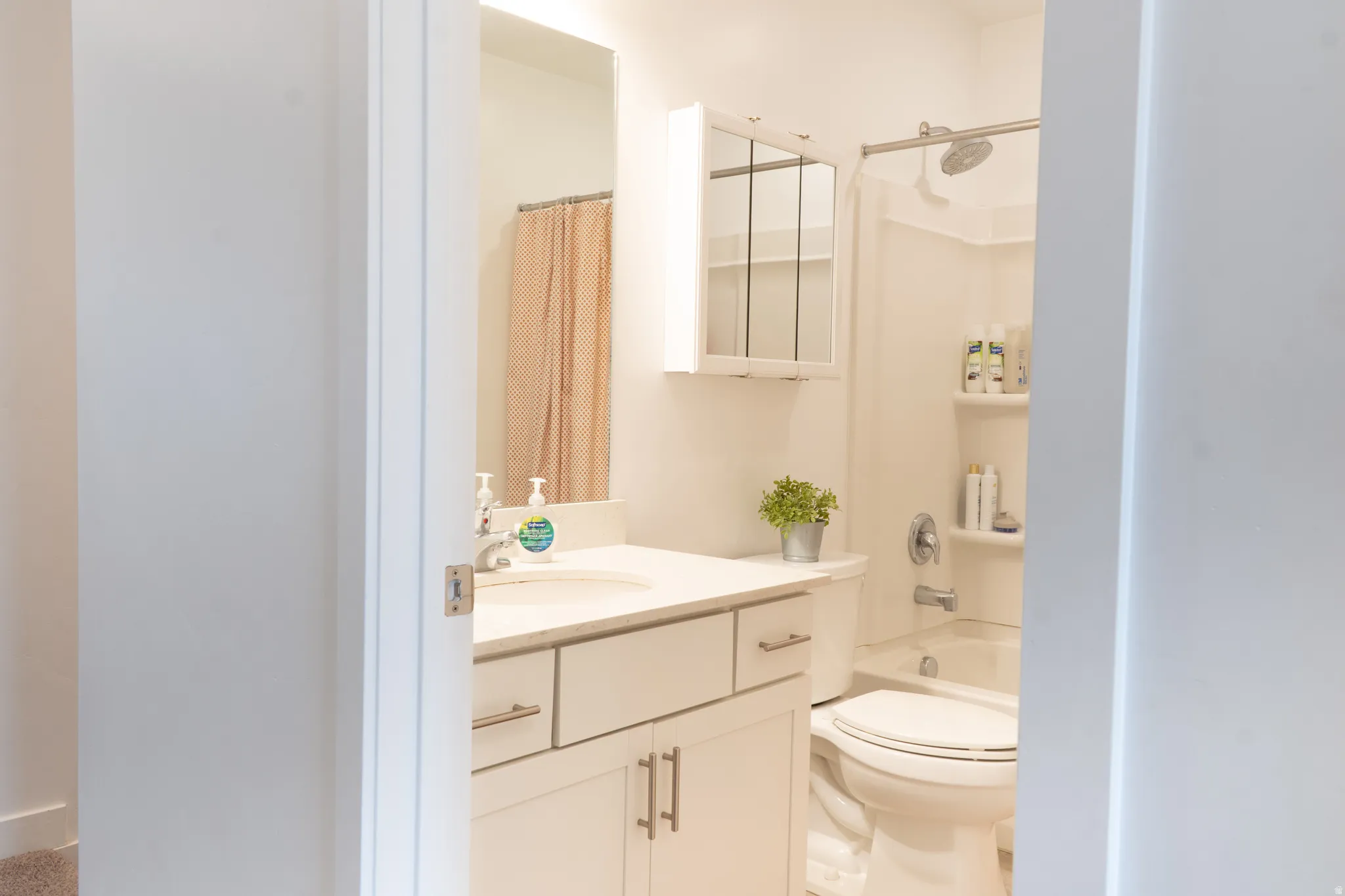 Bathroom with vanity and shower / tub combo