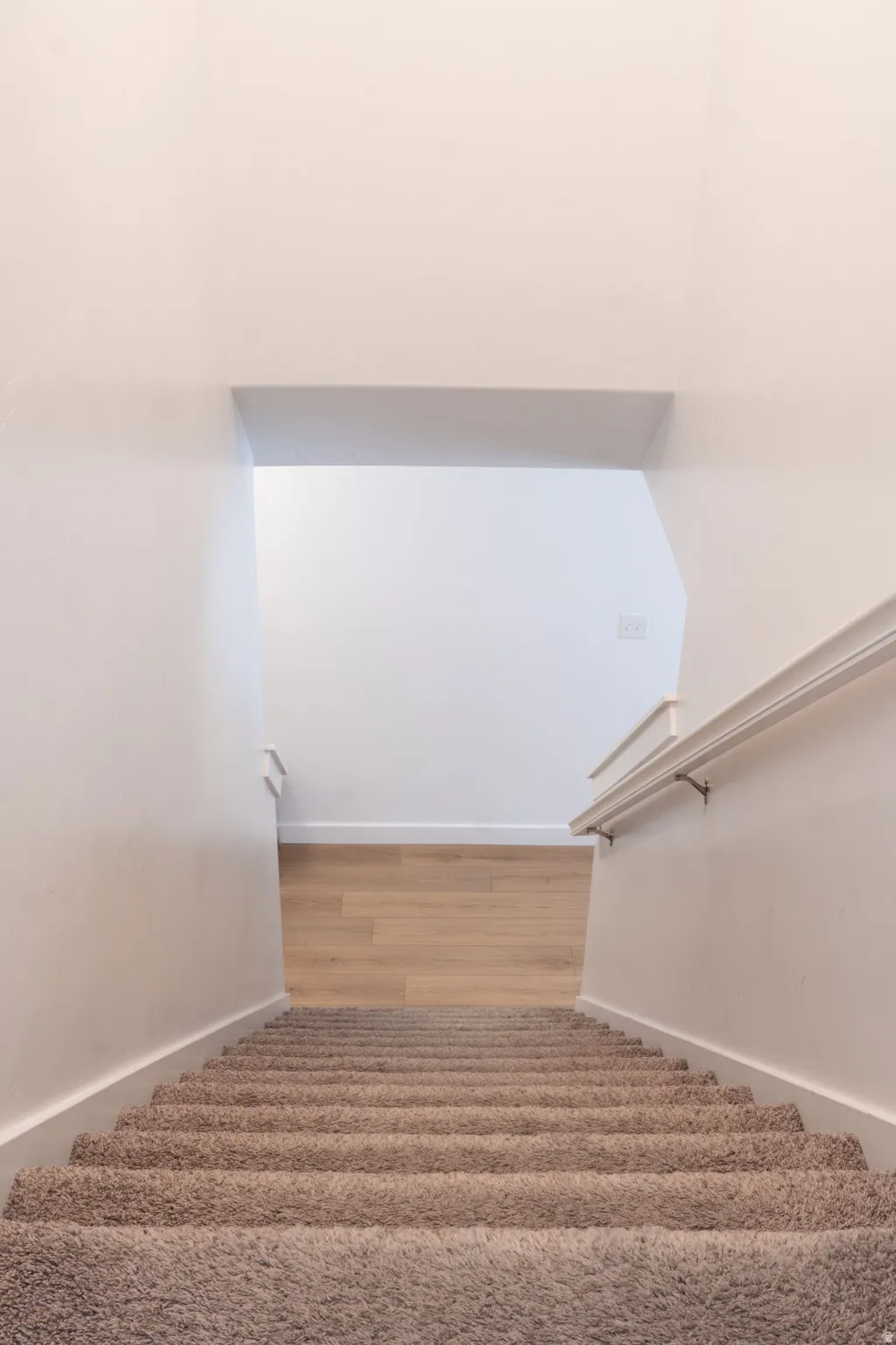 Staircase featuring wood finished floors and baseboards