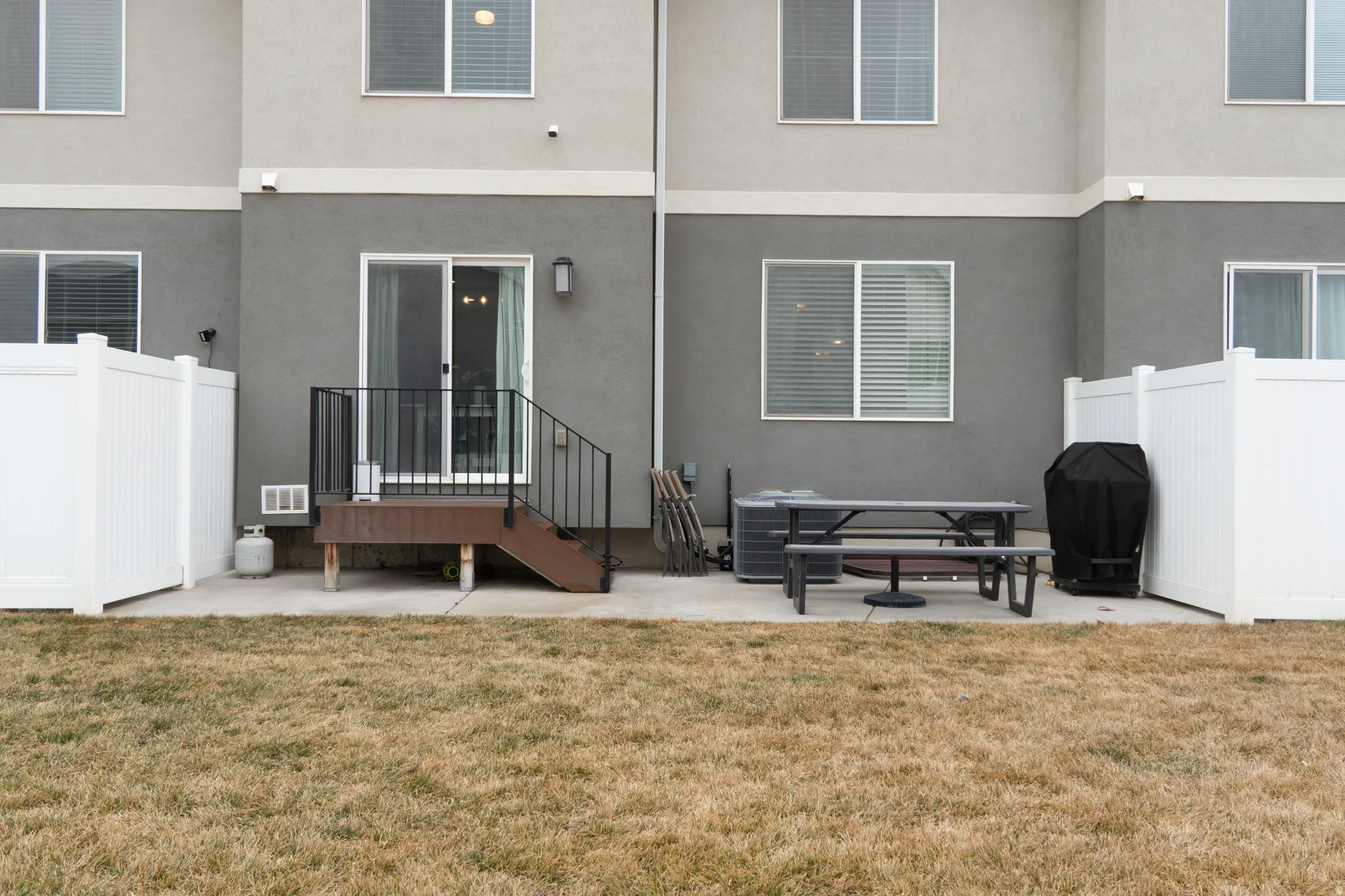 Back of property with a patio and stucco siding