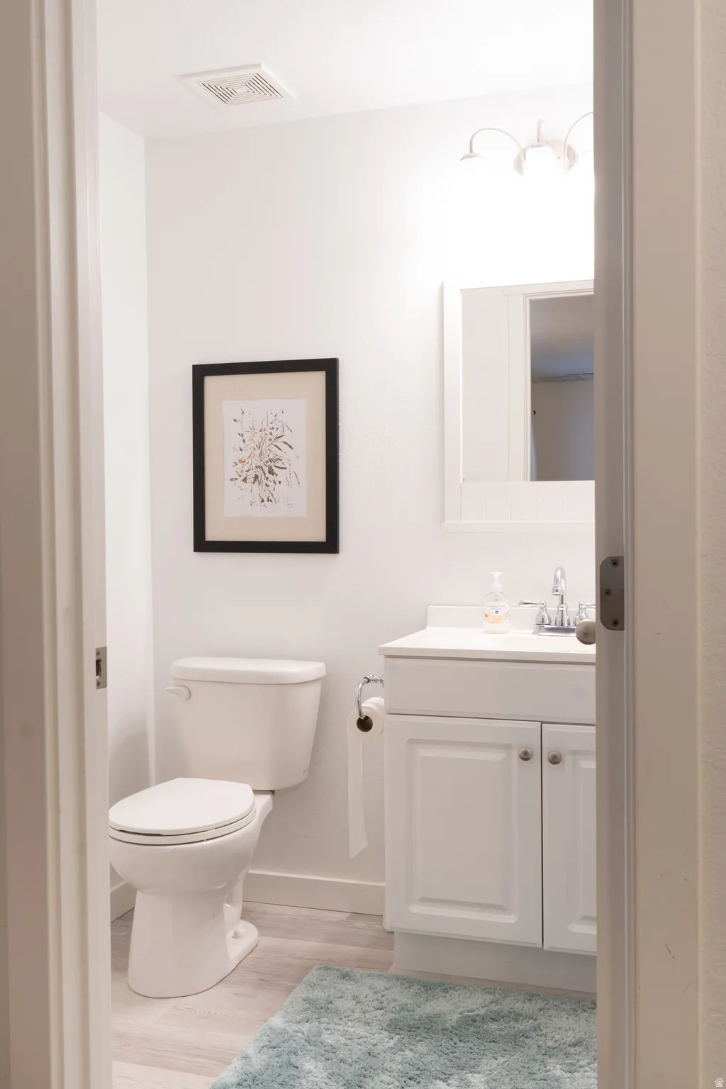 Bathroom featuring vanity and light wood-style floors