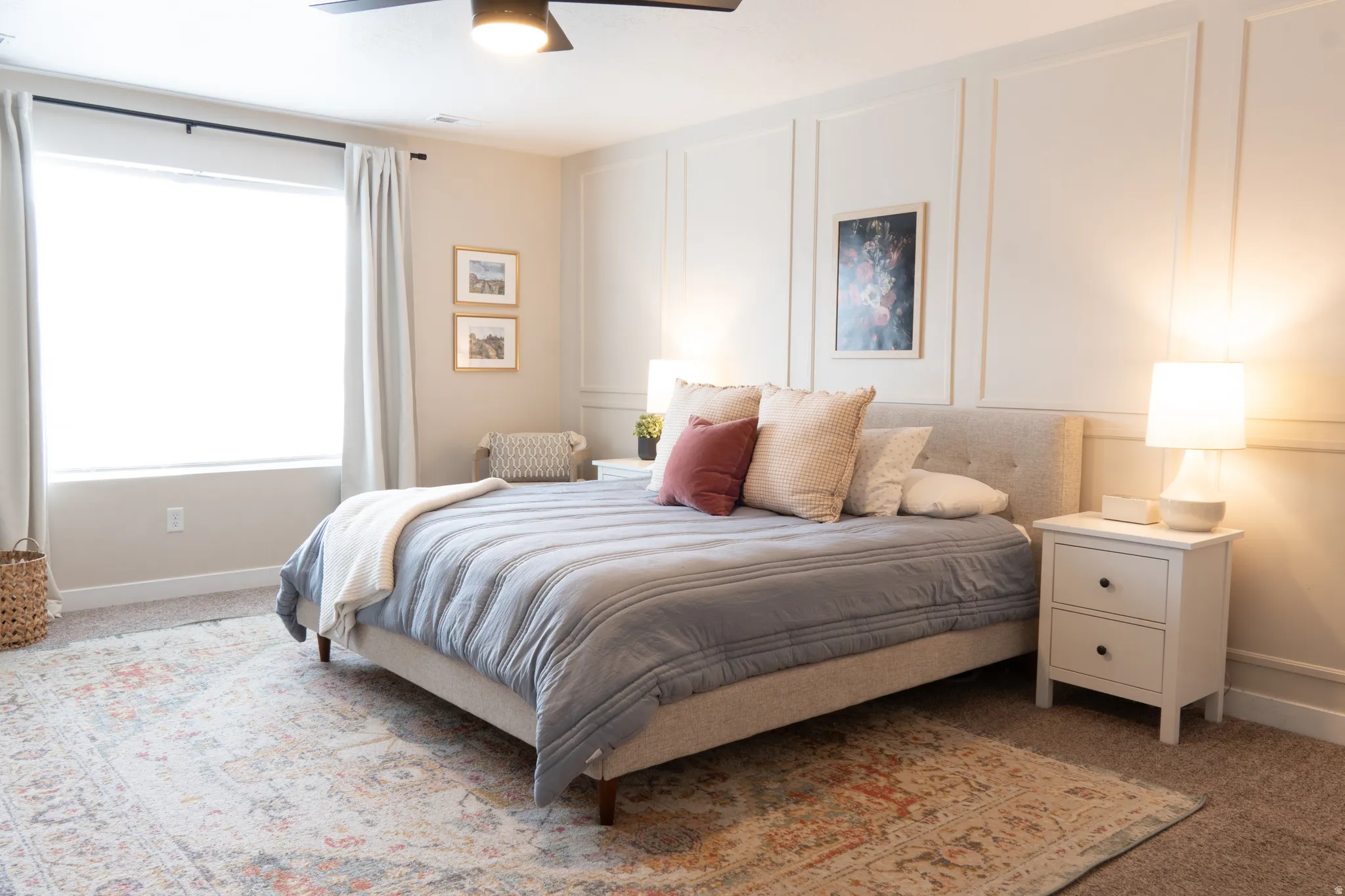 Carpeted bedroom with a decorative wall and a ceiling fan
