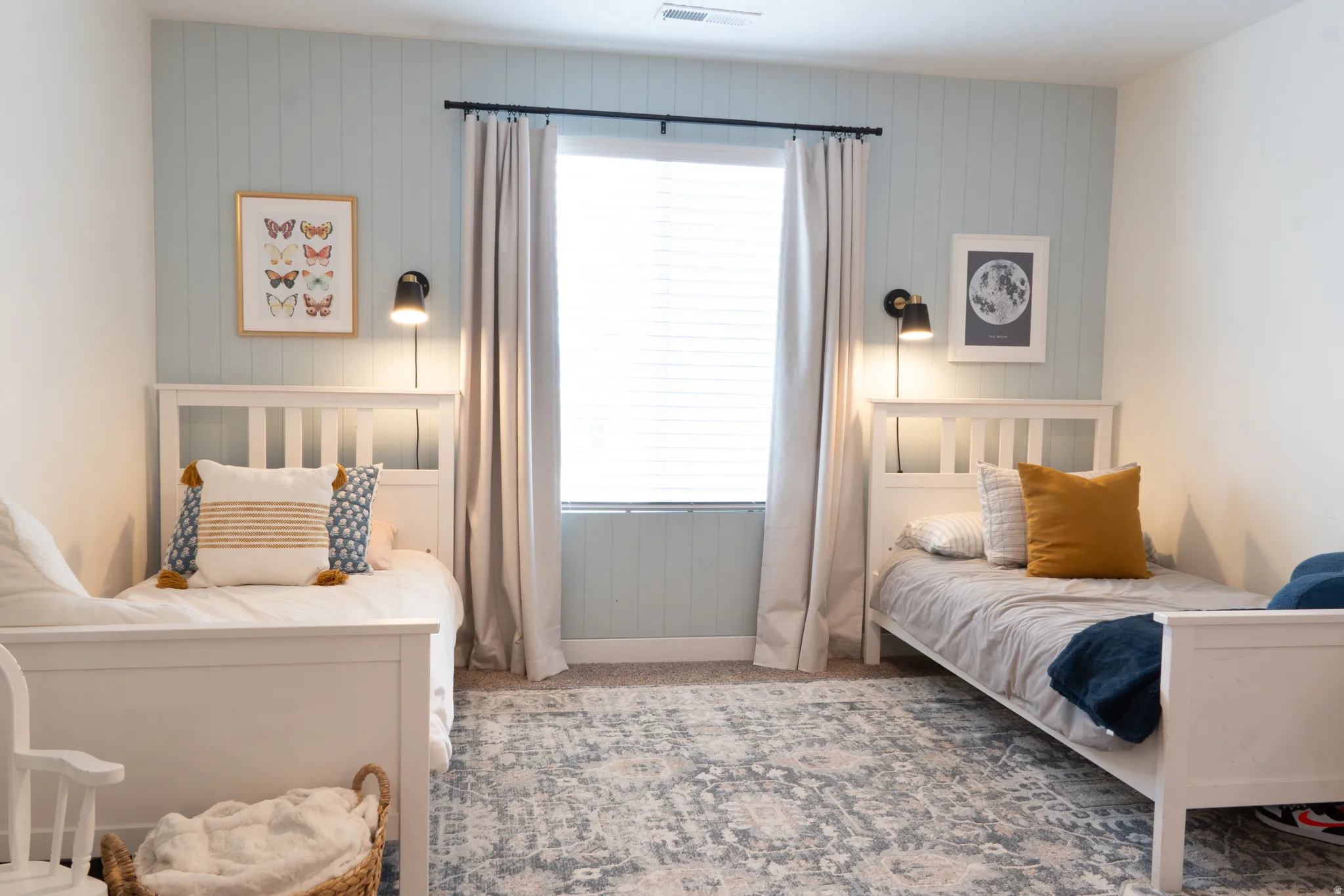 Carpeted bedroom featuring wood walls