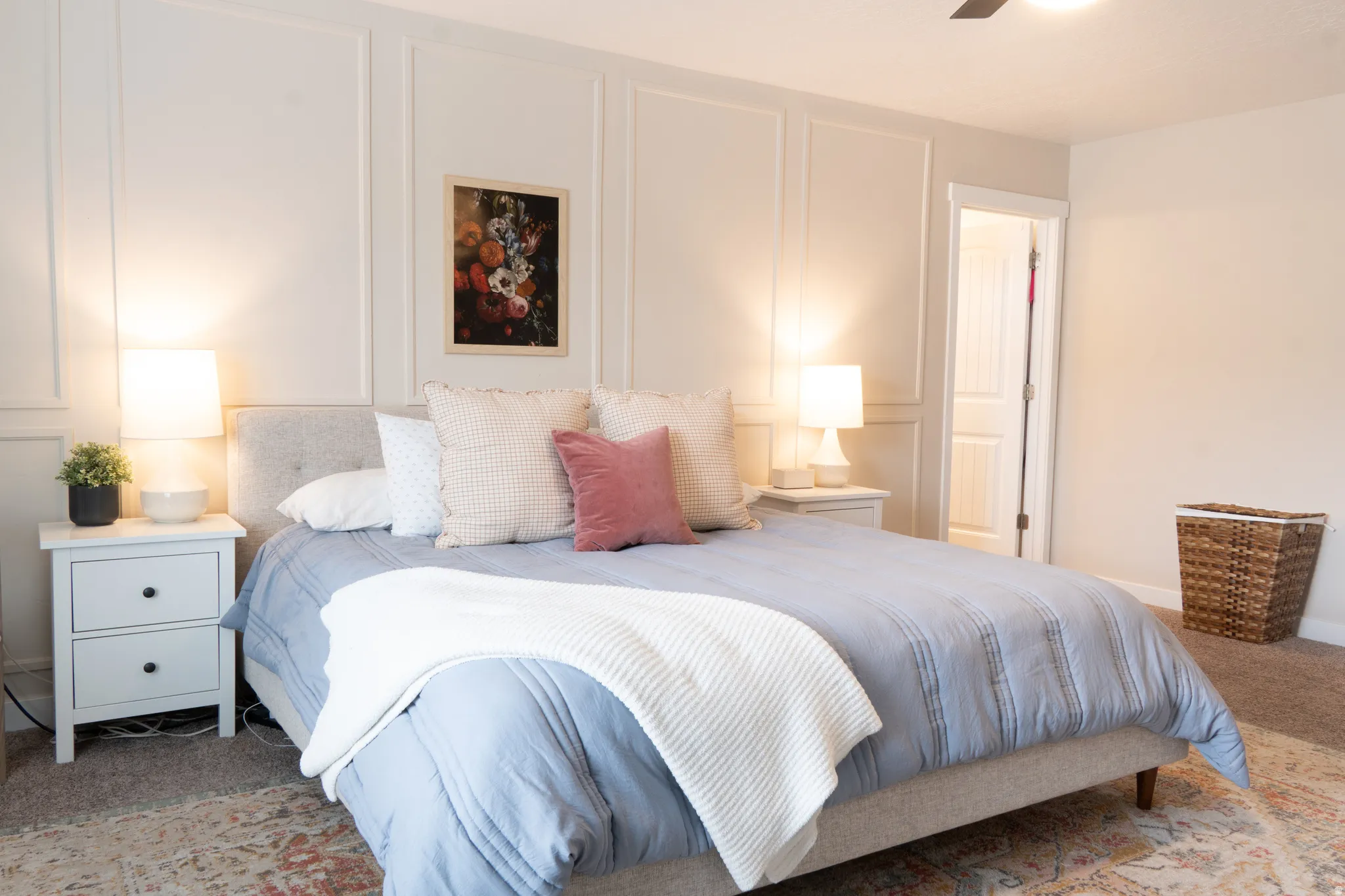 Bedroom featuring a decorative wall, carpet flooring, and ceiling fan