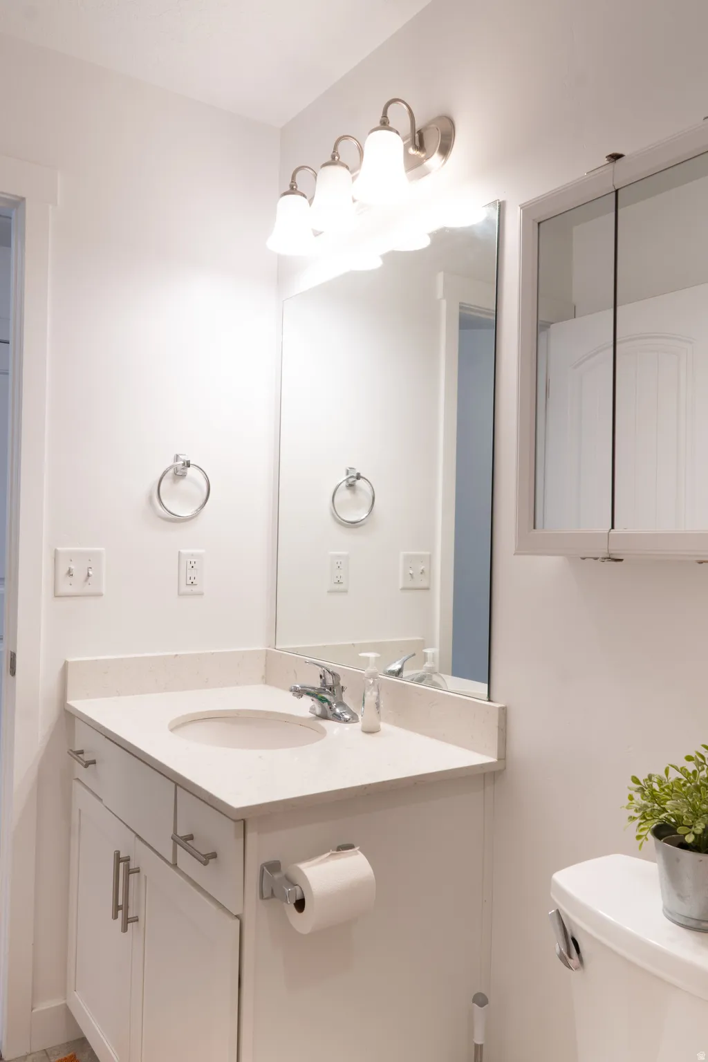 Half bath featuring toilet and vanity
