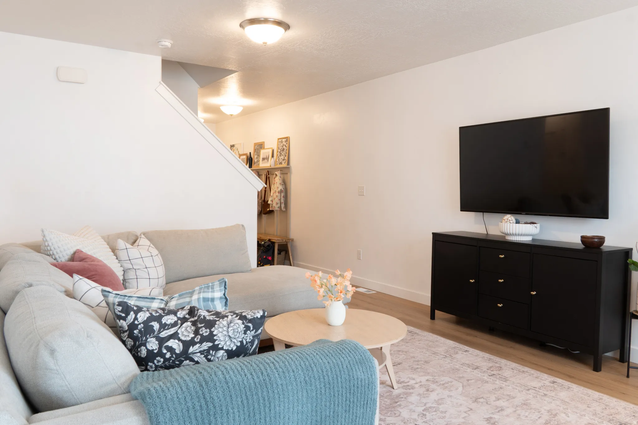 Living area with wood finished floors and baseboards