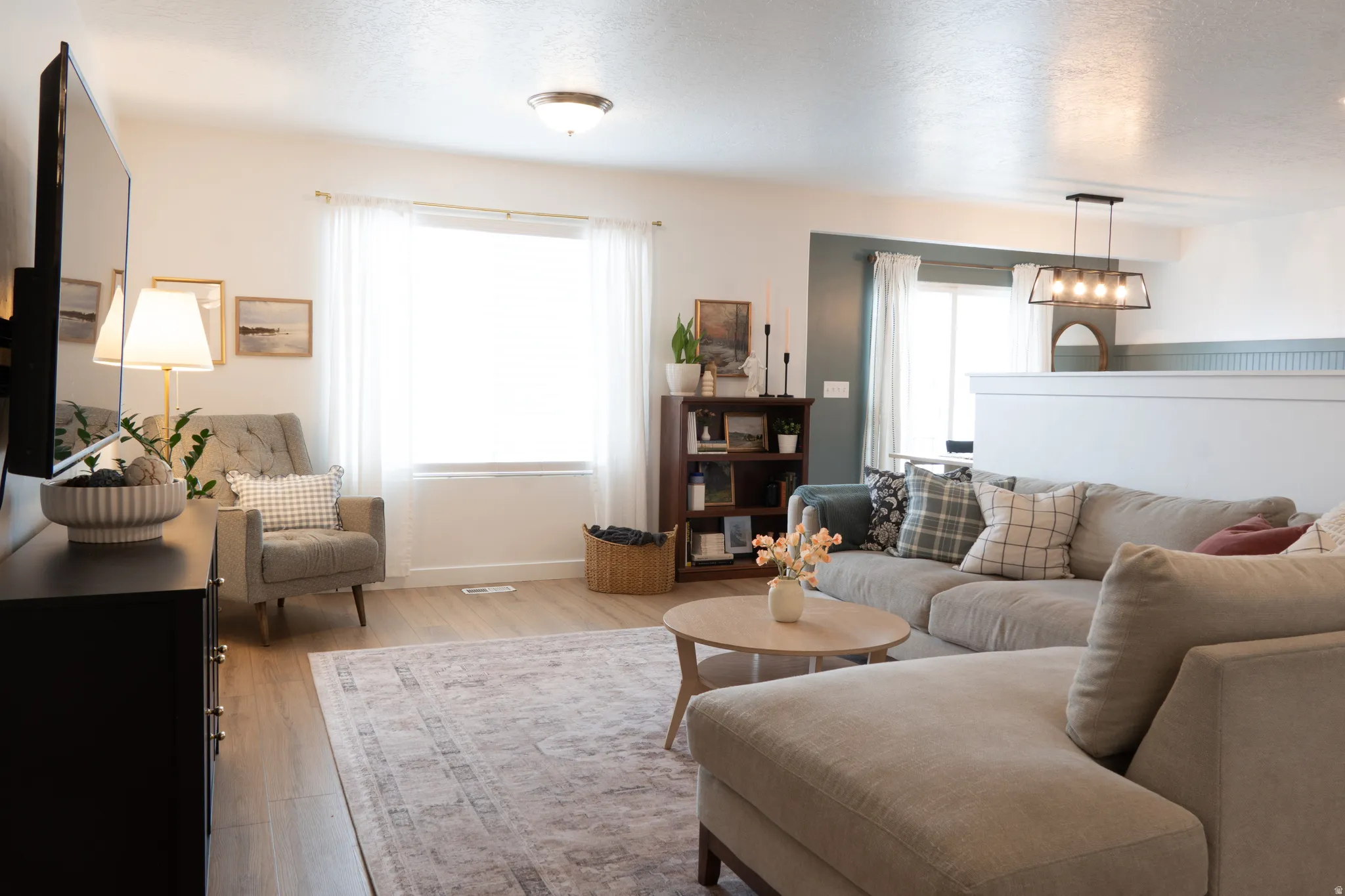 Living area with light wood-style floors and baseboards