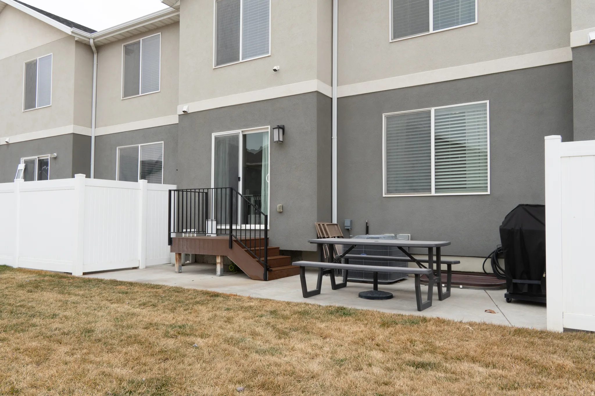 Rear view of property featuring a patio and stucco siding