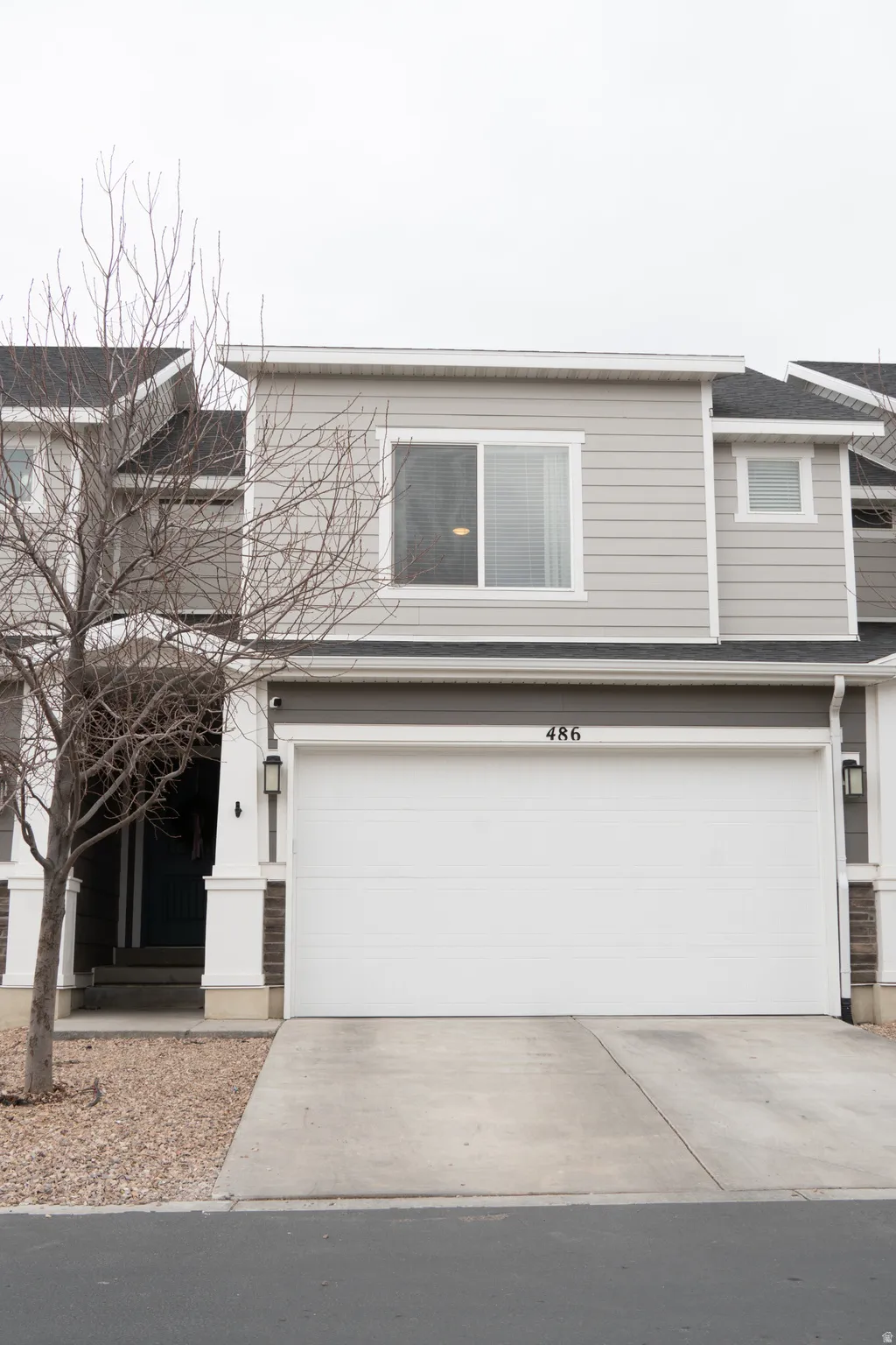 View of front of property featuring a garage and concrete driveway