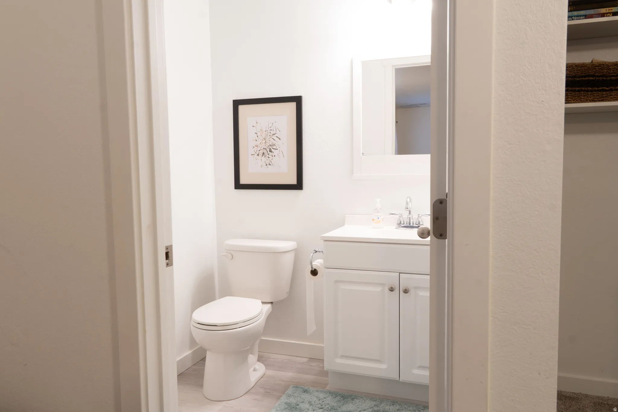 Bathroom with vanity and light wood finished floors