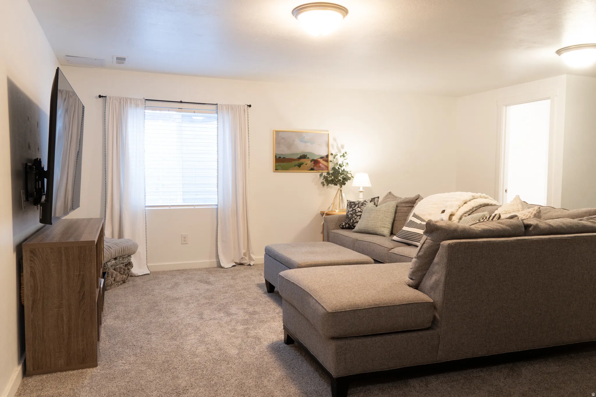 Carpeted living area featuring baseboards