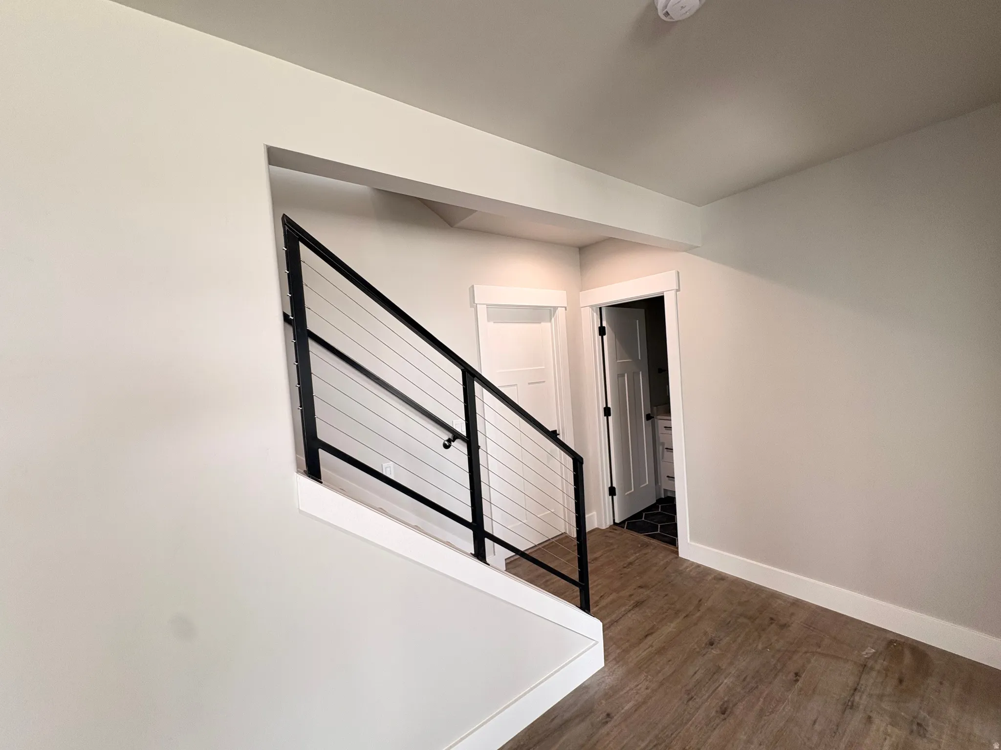 Hallway with stairway and dark wood-style floors