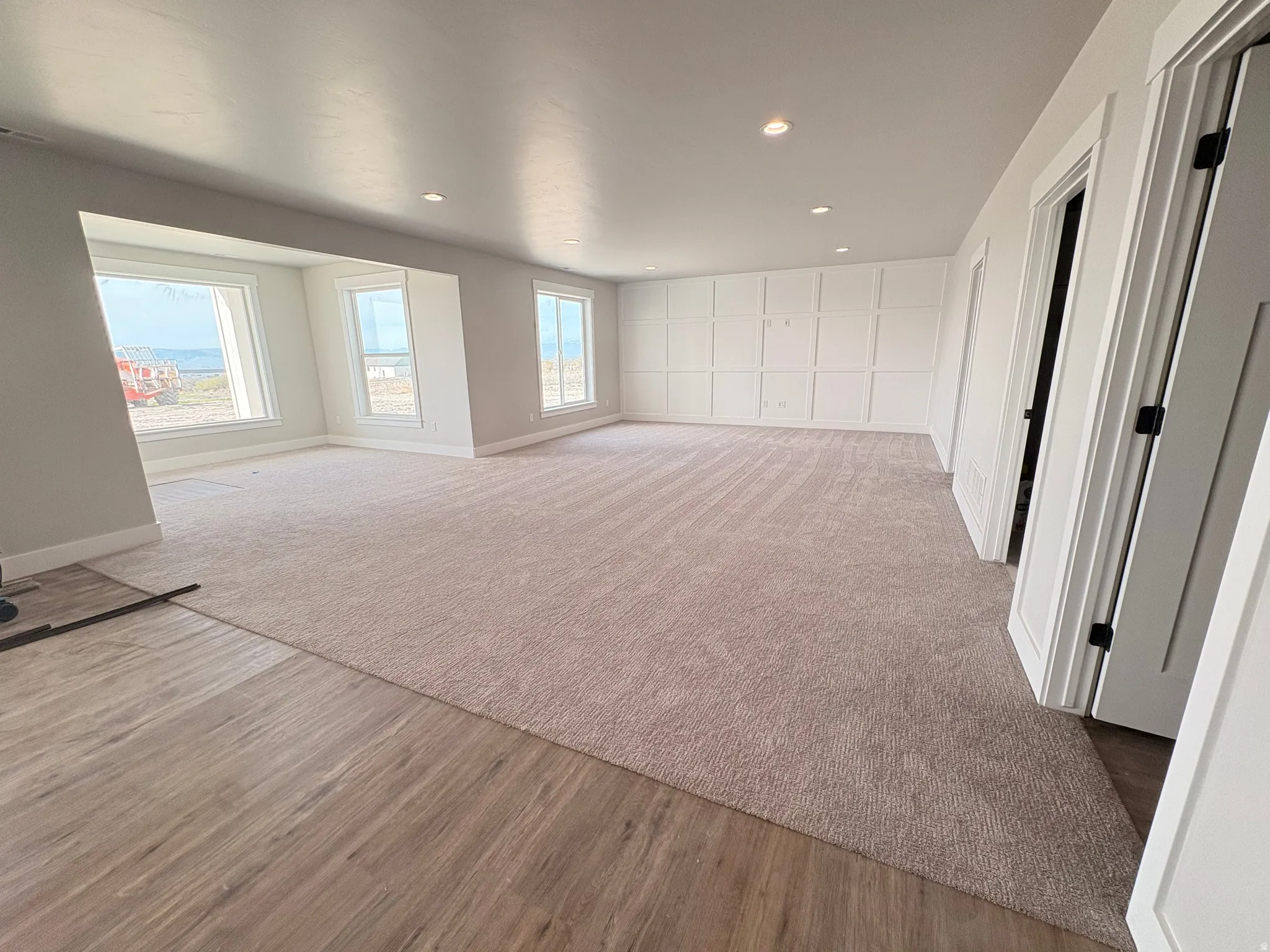 Unfurnished room with recessed lighting and light carpet