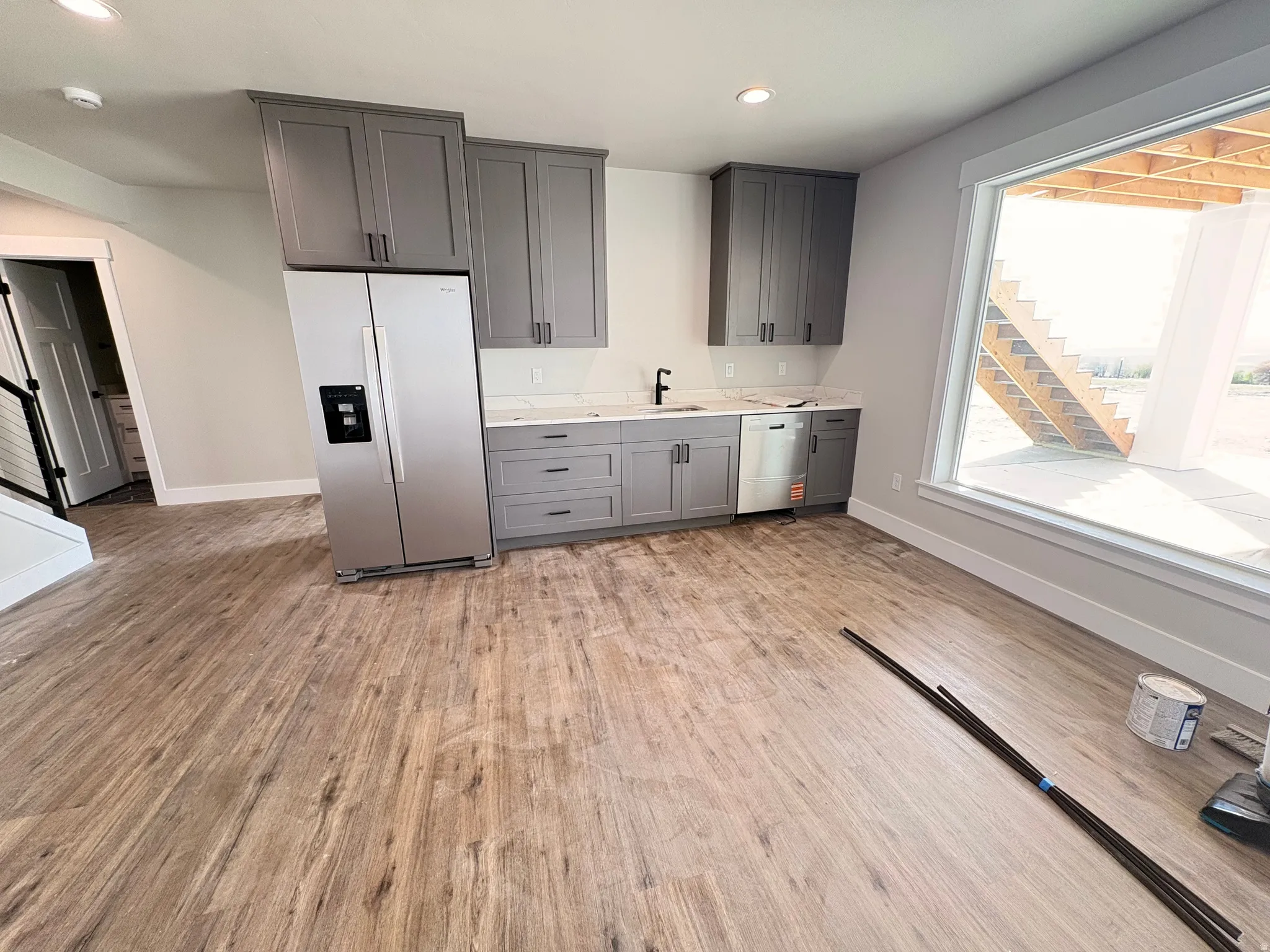 Kitchen featuring stainless steel appliances, gray cabinets, light wood-style flooring, and recessed lighting