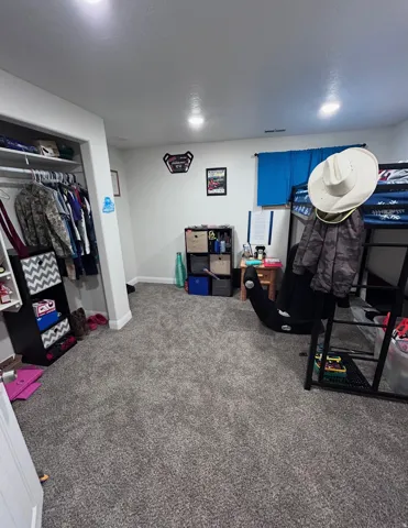 Game room with carpet flooring and baseboards