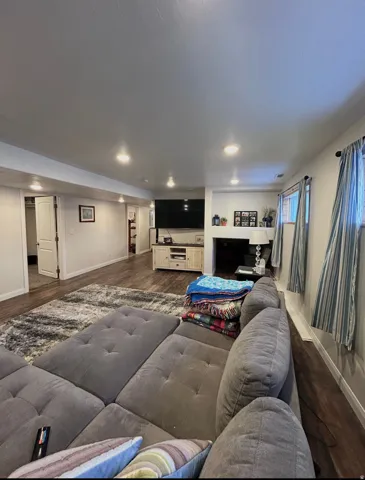 Living area with dark wood-type flooring