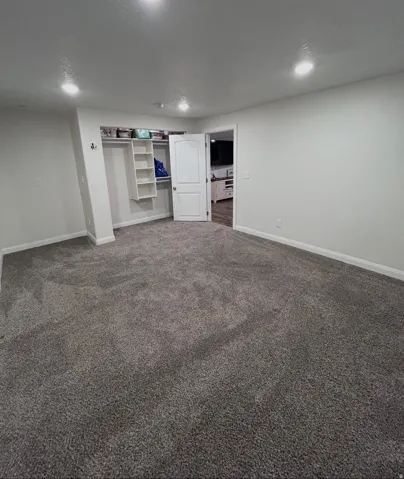 Finished basement with baseboards and carpet flooring