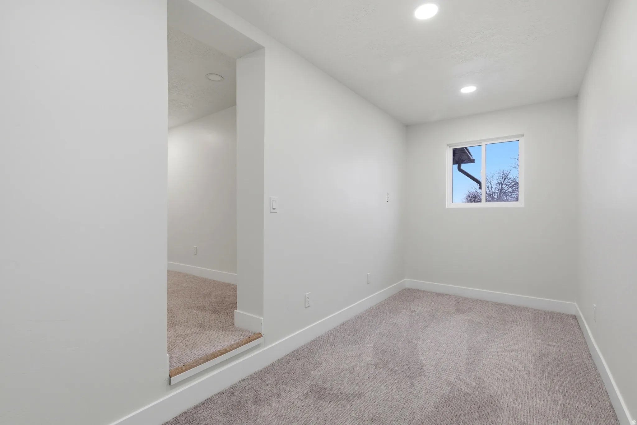 Unfurnished room with carpet flooring and recessed lighting