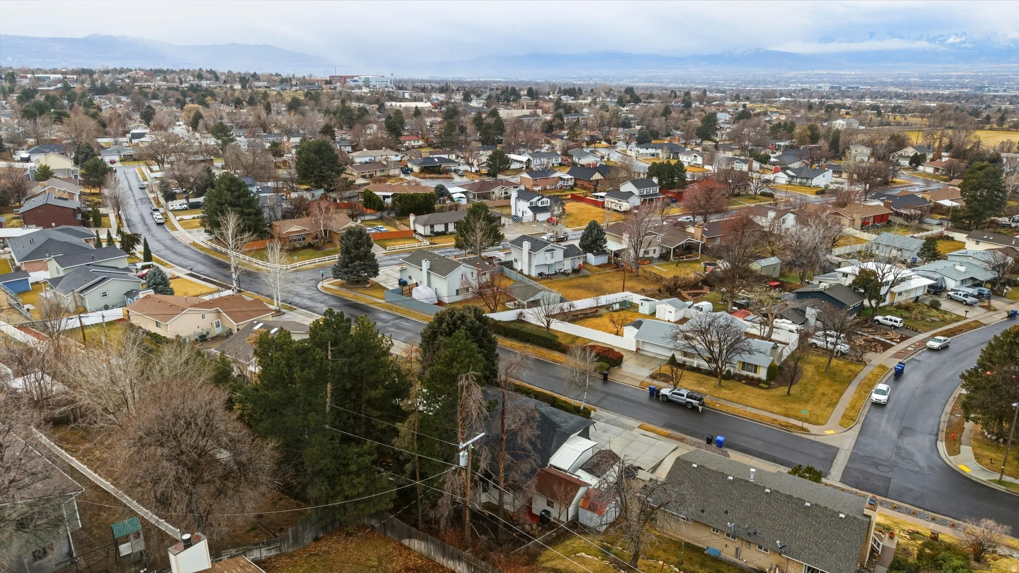 Aerial view of residential area featuring a mountainous background