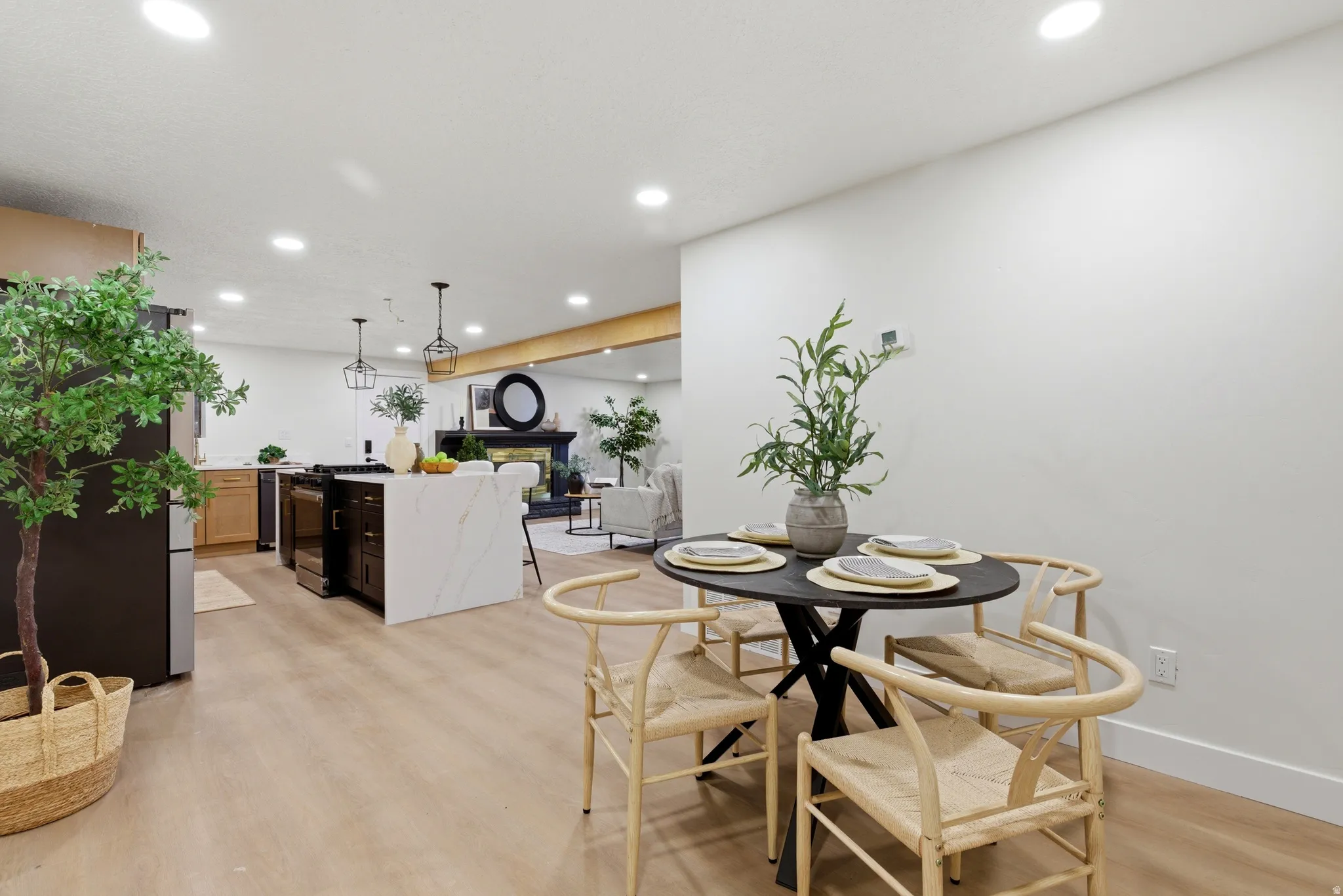 Dining space with recessed lighting and light wood-style floors
