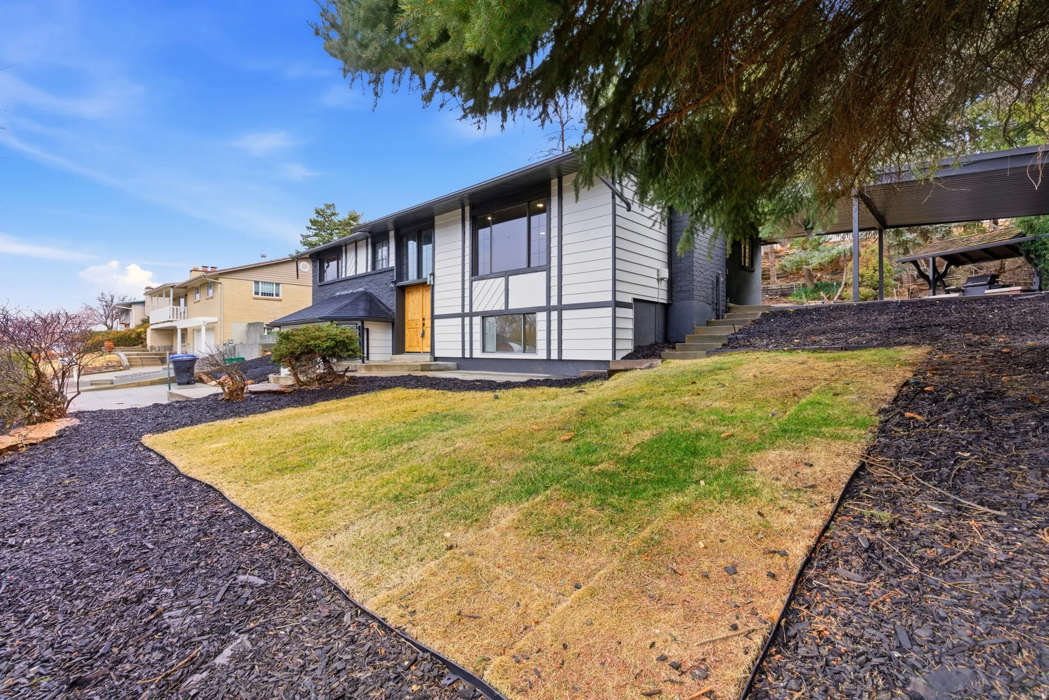 Back of property featuring a yard and a patio area