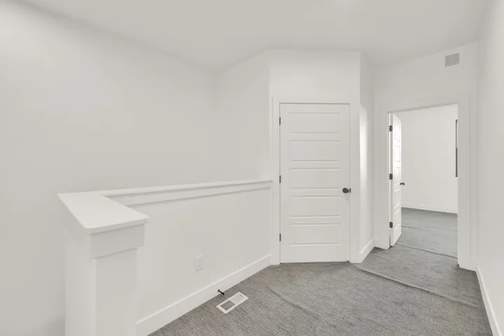 Empty room featuring carpet floors and baseboards