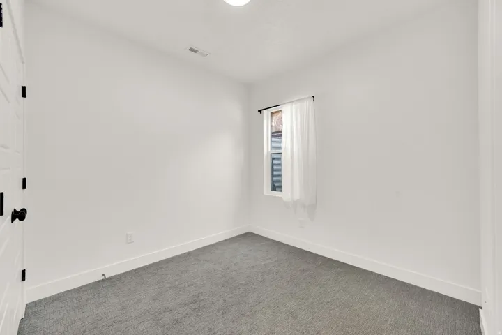 Unfurnished room featuring baseboards and carpet floors