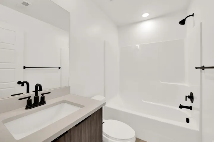 Bathroom featuring vanity and bathtub / shower combination